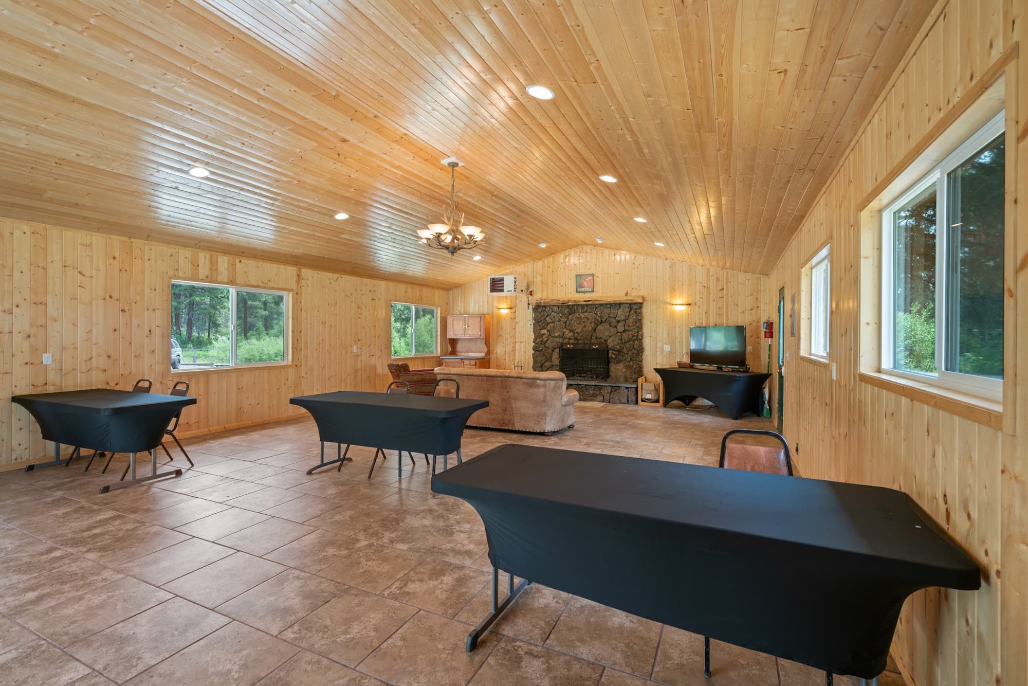 Recreation hall interior at Crater Lake Resort with vaulted wood ceiling and banquet seating