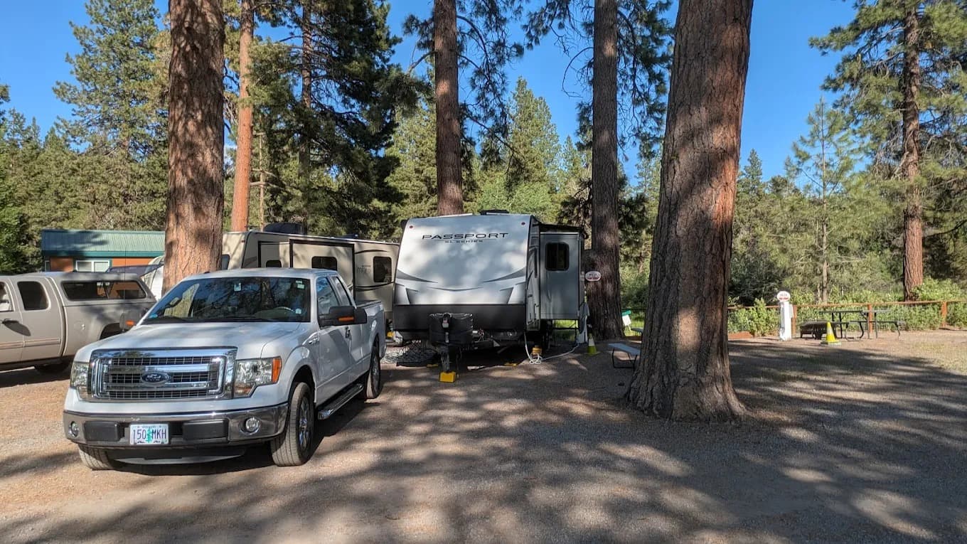 Truck and travel trailer at a spacious back-in RV site