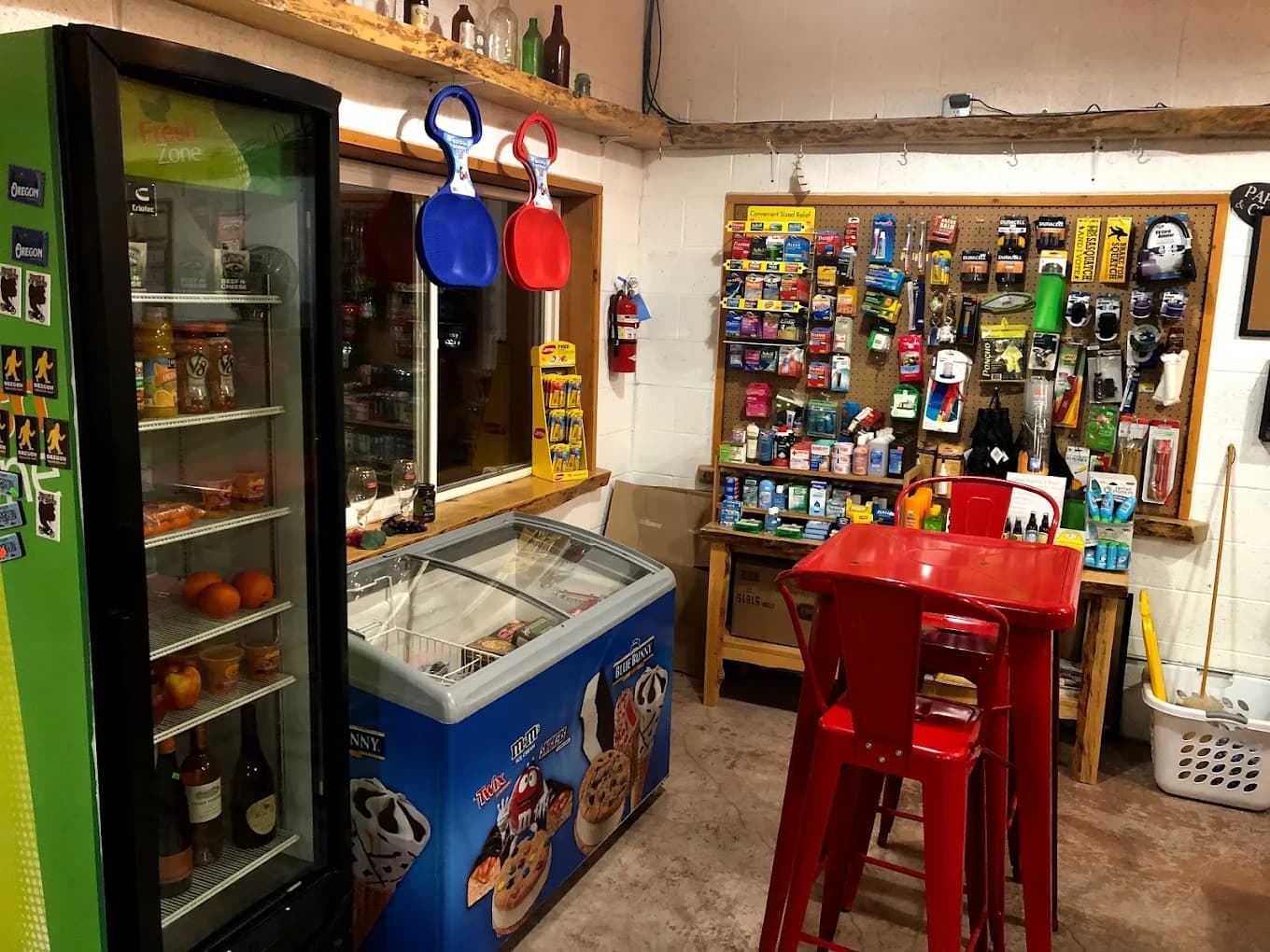 Inside the store — drinks cooler, ice cream freezer, snacks, and seating