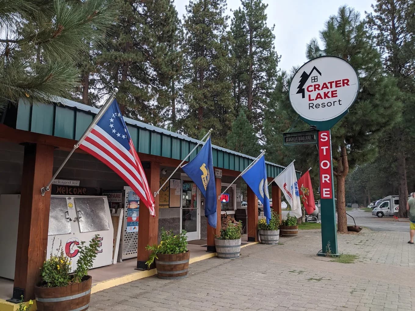 Front of the Crater Lake Resort general store with American flag and round sign