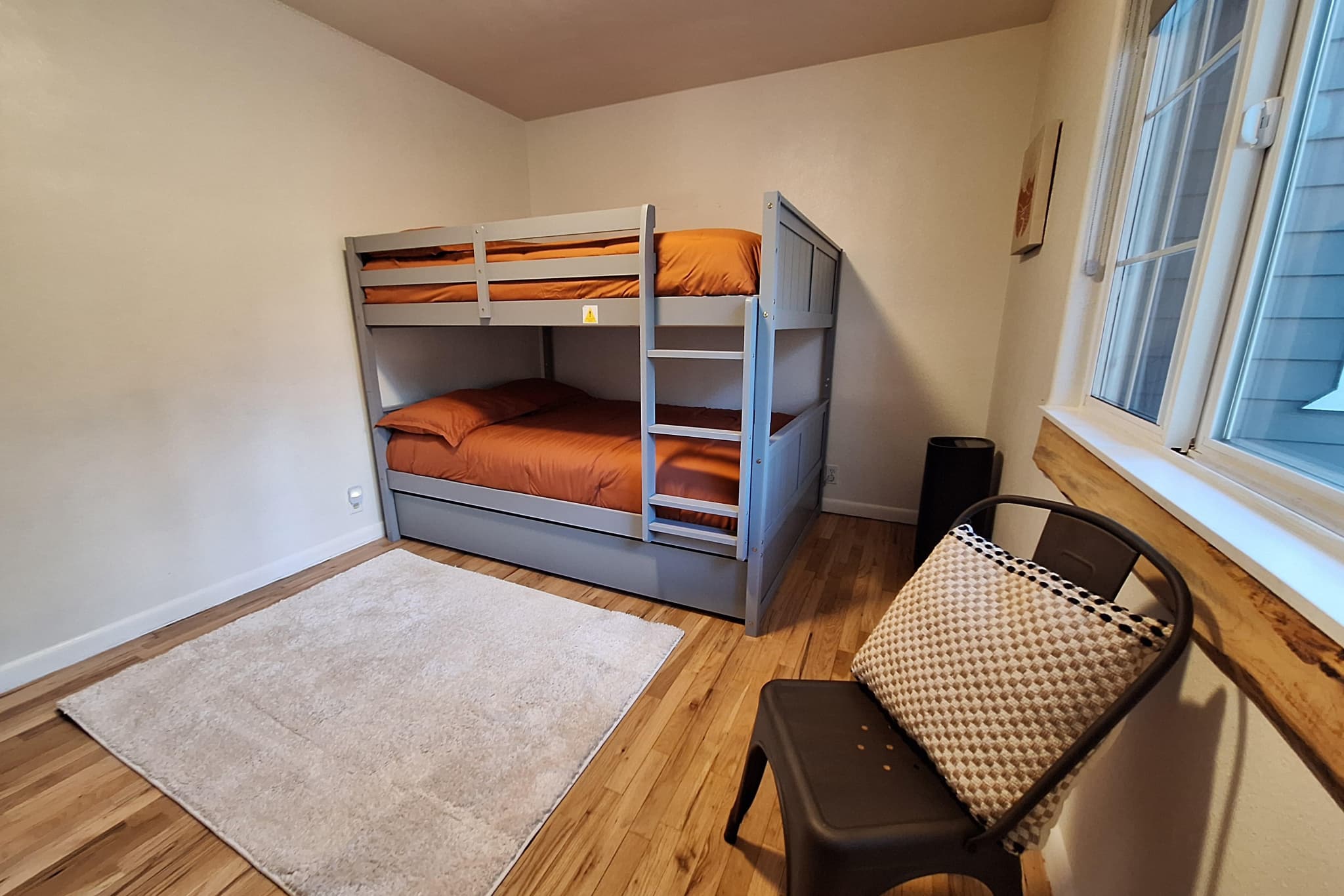 Second guest bedroom with bunk bed and large window
