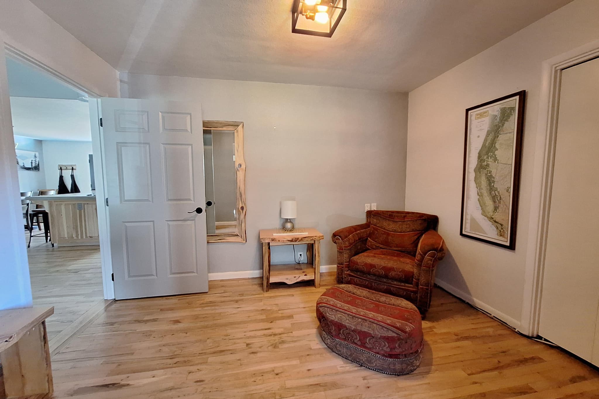 Sitting nook with leather chair, ottoman, and Crater Lake map